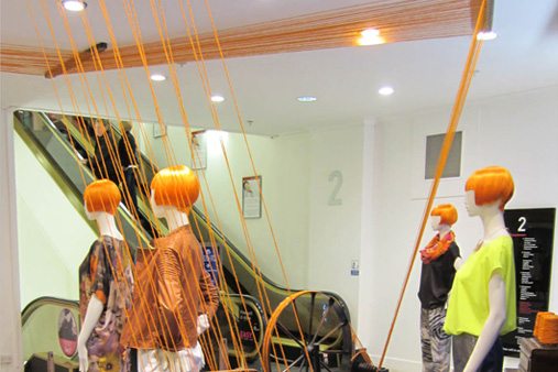 Prop Studios designed the visual merchandising scheme so that the wool would twist into the window and through the vintage machinery, forming a striking art installation