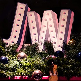 Close-up image of bespoke lit lettering, designed exclusively for Jack Wills by Prop Studios